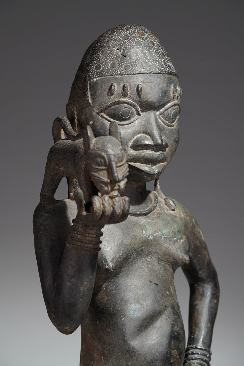 A bronze sculpture of a servant in the style of Benin