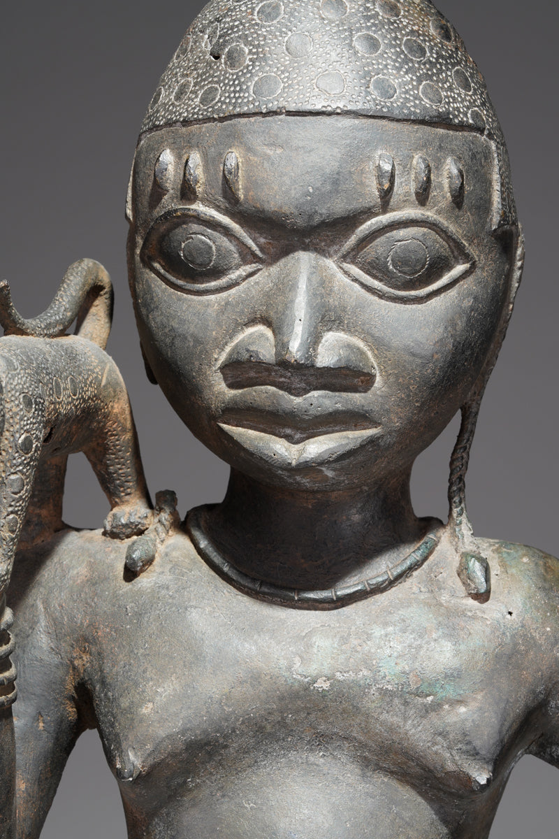 A bronze sculpture of a servant in the style of Benin