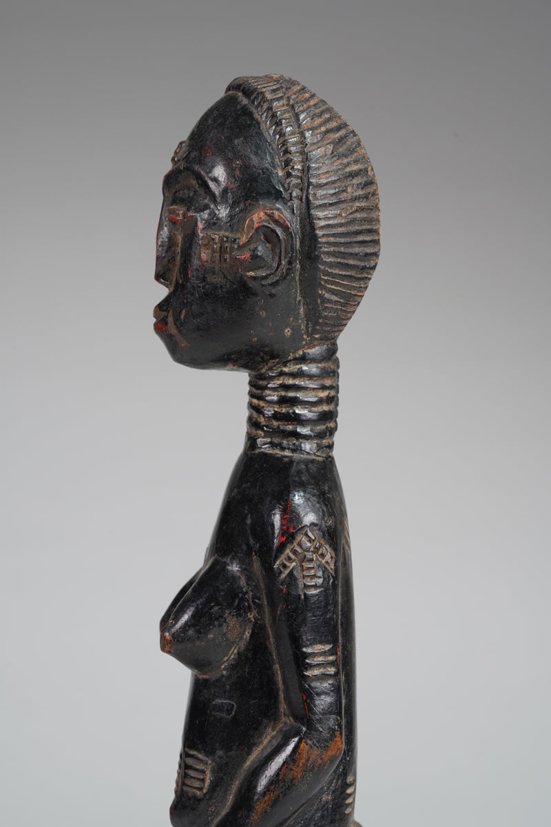 A female Baule sculpture from the Beomi region