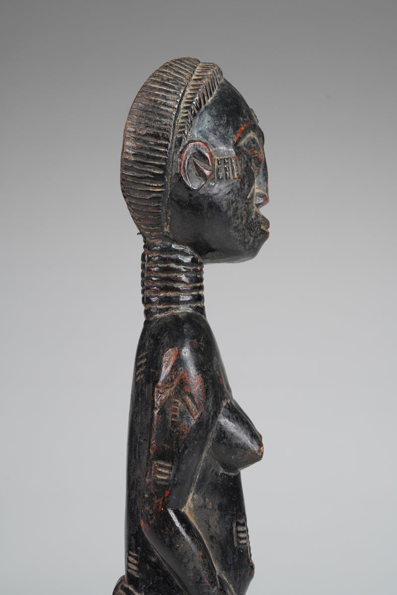 A female Baule sculpture from the Beomi region