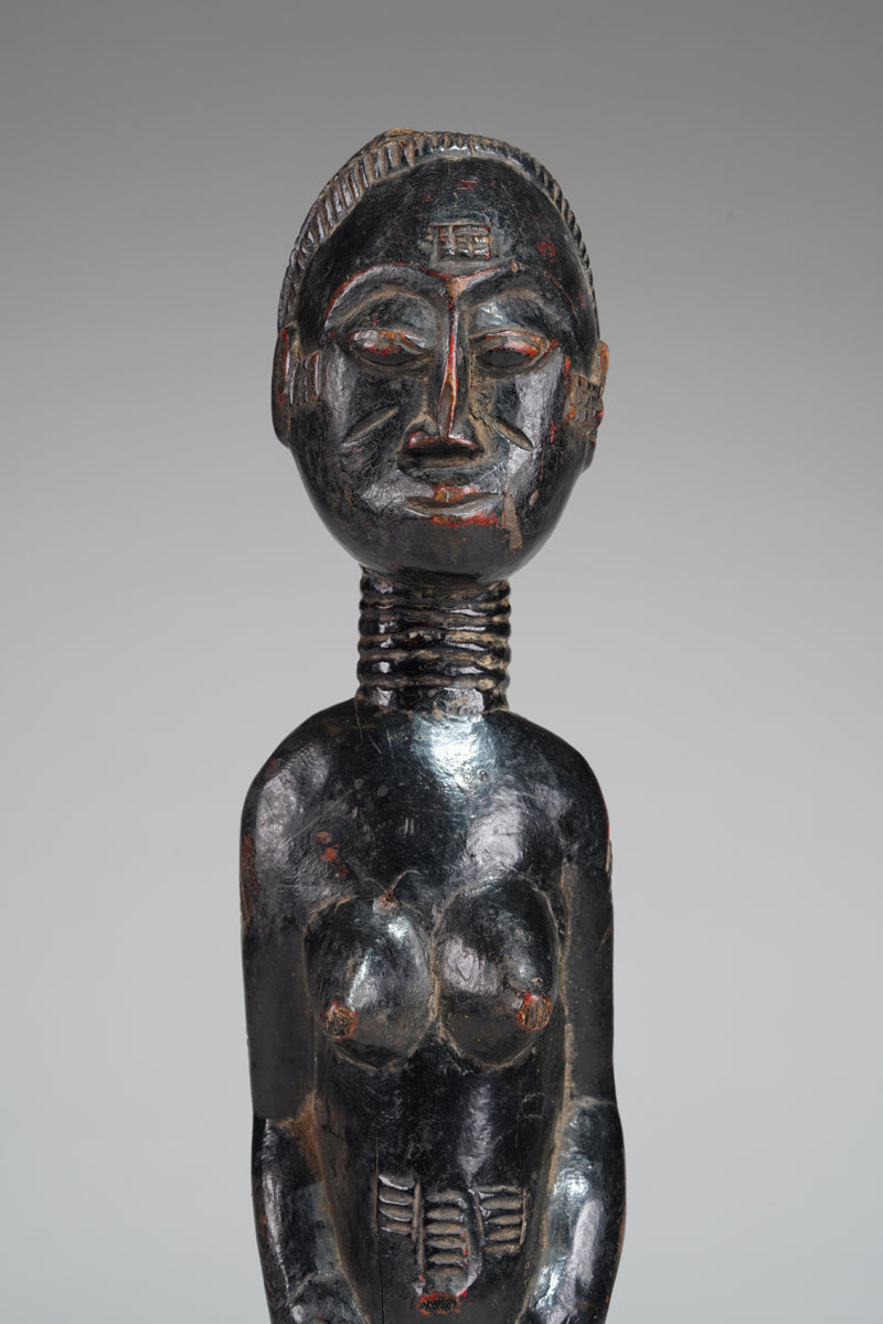 A female Baule sculpture from the Beomi region