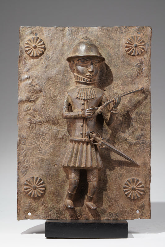 A bronze relief plaque of a Portuguese soldier, in the style of Benin