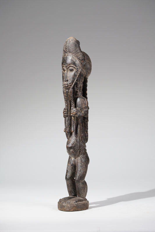 A male Baule sculpture of wiseness