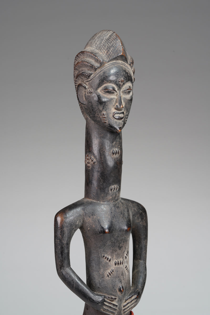 A male Baule sculpture from the Beomi region