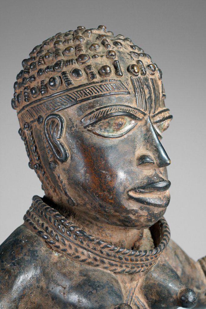 A female Bronze sculpture, in the style of Benin