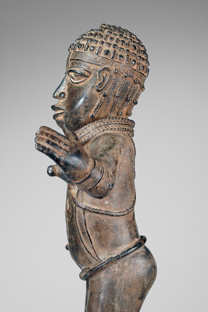 A female Bronze sculpture, in the style of Benin