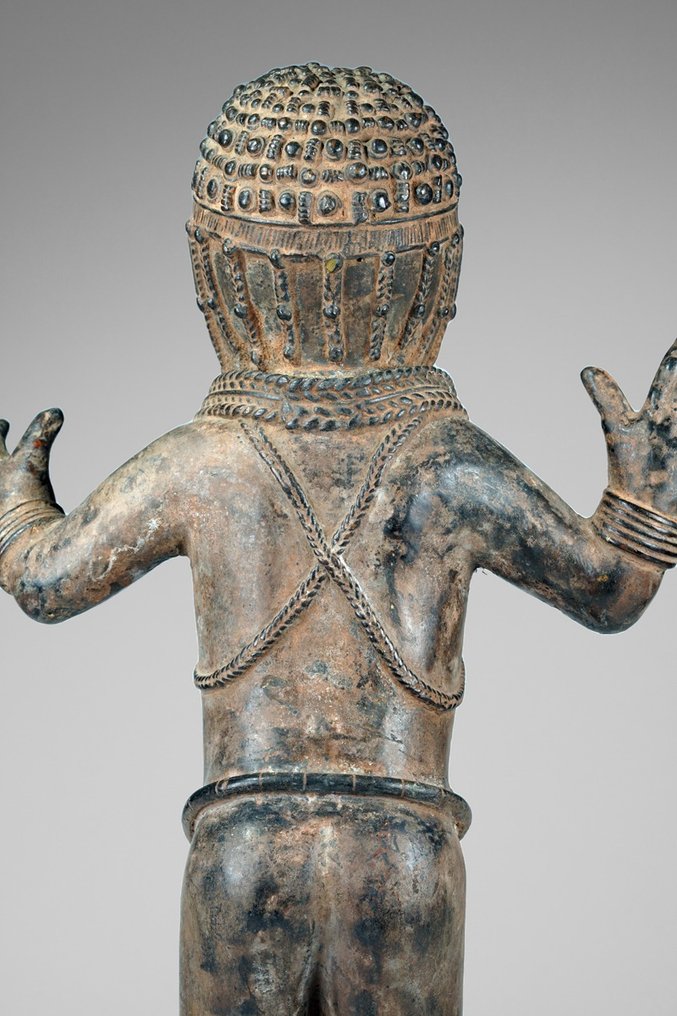 A female Bronze sculpture, in the style of Benin