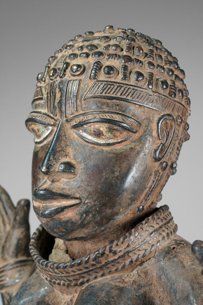 A female Bronze sculpture, in the style of Benin