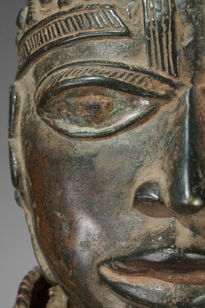 A female Bronze sculpture, in the style of Benin