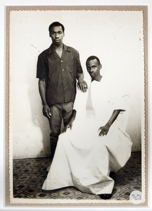 Silver gelatin print of two men in black and white cloths